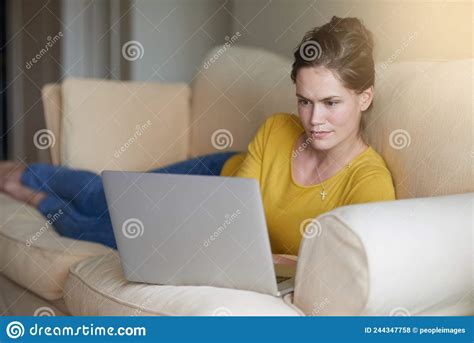 Status Chilling At Home Shot Of An Attractive Young Woman Using Her