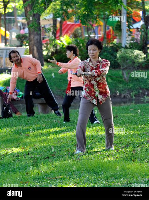Woman Performing Tai Chi Exercises With A Large Sword In Lumpini Park Bangkok Stock Photo Alamy