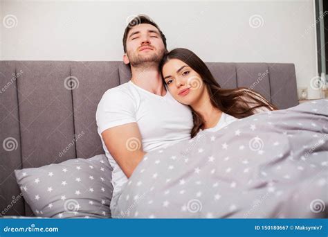 Happy Couple Having Fun In Bedyoung Couple In Bedroom Enjoying Each