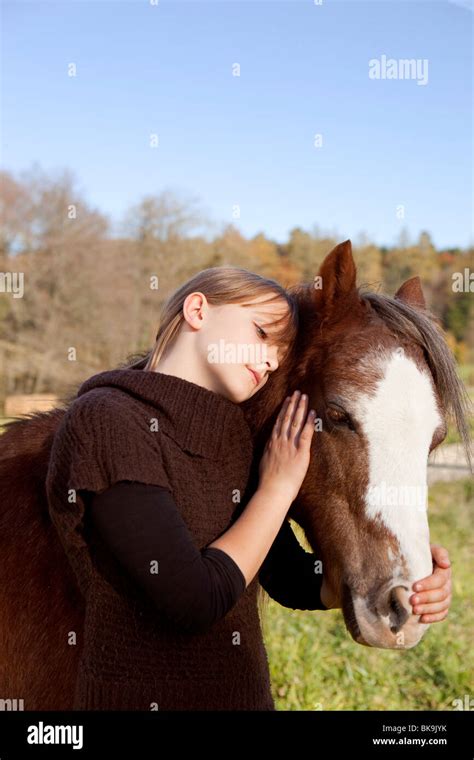 Girl Stroking A Horse Stock Photo Alamy
