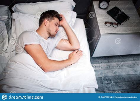 Young Man In Bed In The Morning Top View Of Tired Guy Sleeping He