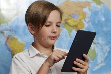 Portrait Of A School Boy Using Digital Tablet Close Up Stock Photo