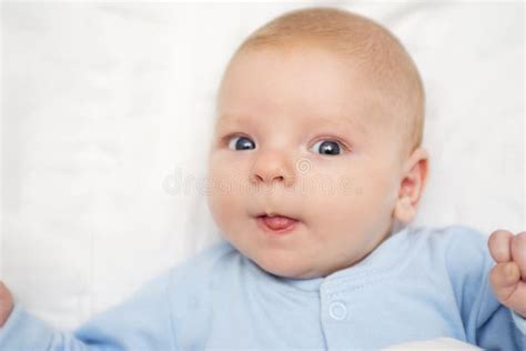 Portrait Of A Cute Baby Lying Down On A Bed Baby On White Cloth Lying