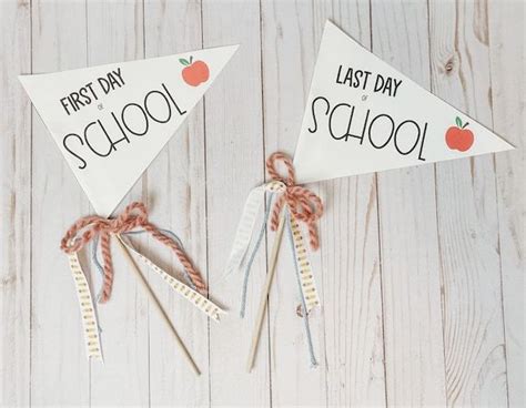 Two Paper Pennants With The Words Last Day School And An Apple On Each One