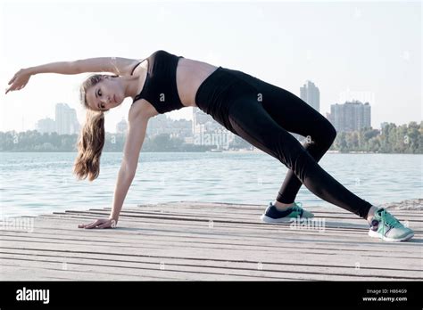 Young Pretty Slim Fitness Sporty Woman Stretches At Yoga Poses During