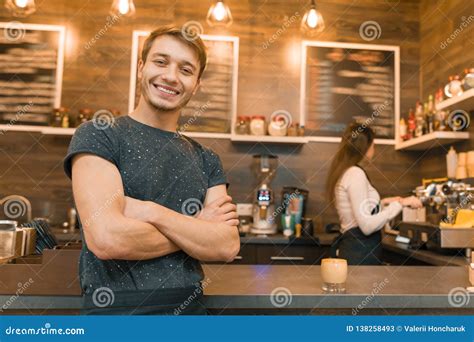 Young Male Barista Coffee Shop Worker Smiling Looking At The Camera