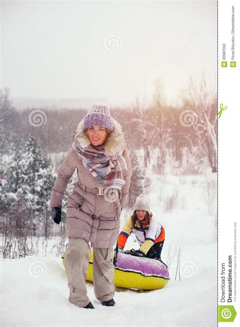 Two Female Friends Having Fun On Snow Hill Stock Photo Image Of