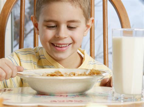 Young Boy Eating Cereal At Breakfast Table Eating Cereal Easy Meals