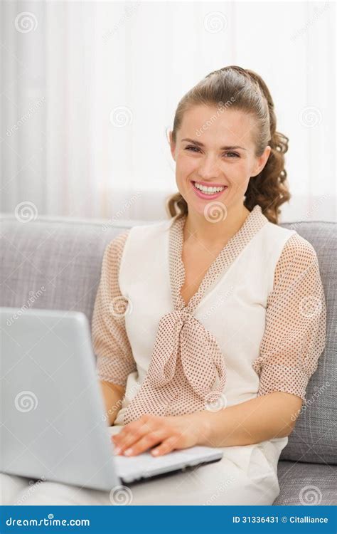 Happy Housewife Sitting On Divan And Using Laptop Stock Image Image