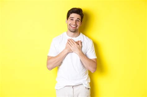 Free Photo Image Of Grateful Handsome Guy In White T Shirt Holding