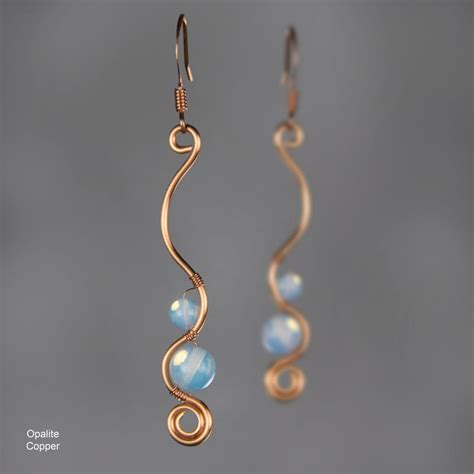 The Earrings Are Made With Gold Wire And Blue Opalite Beads Hanging