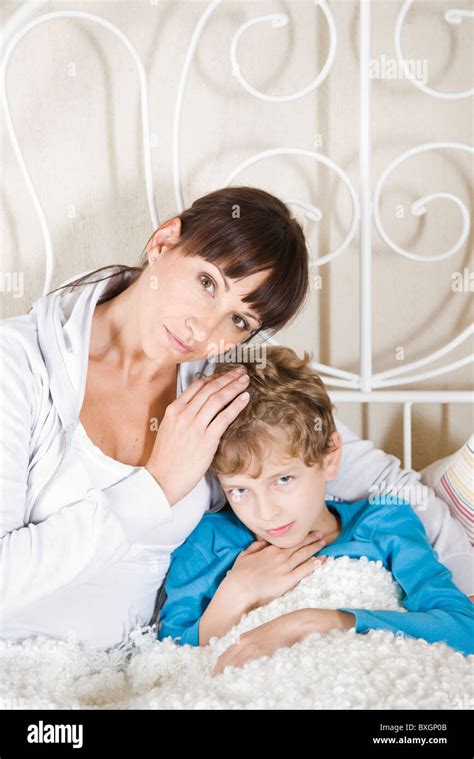 Mother Taking Care Of Sick Son Stock Photo Alamy