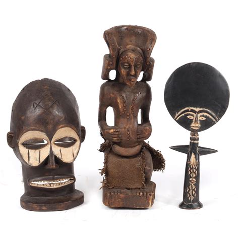 Lot Three African Tribal Carved Wood Statues And A Painted Mask