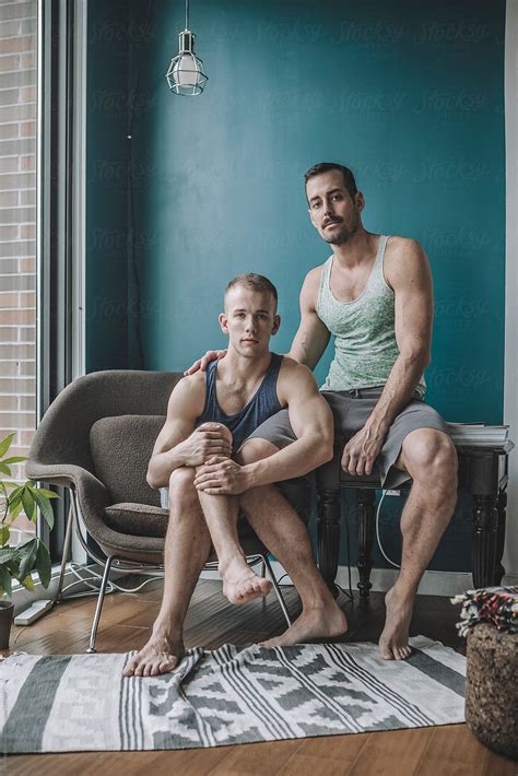 Informal And Casual Portrait Of A Gay Male Couple At Home In Their