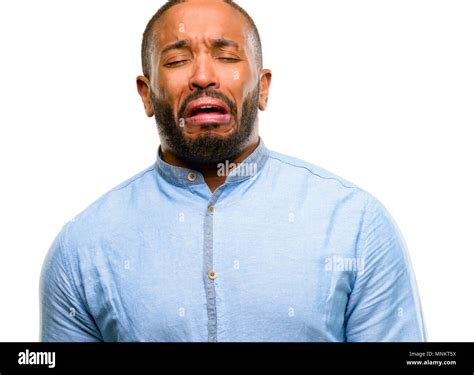 african american man with beard crying depressed full of sadness expressing sad emotion isolated