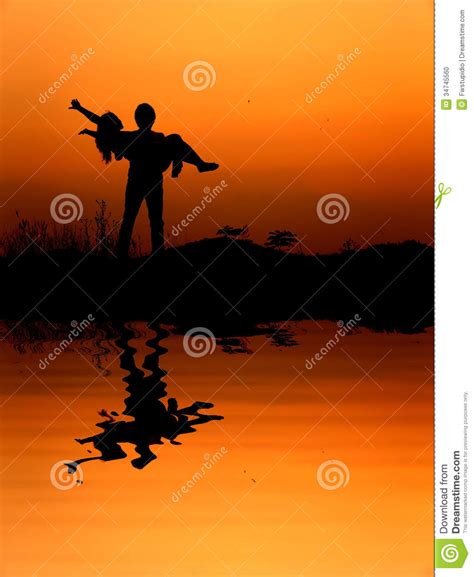 Reflection Of Man And Woman Love Silhouette In Sunset Stock Photo