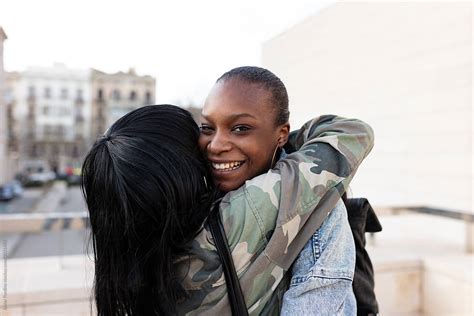 Two Black Woman Friends Having Fun In Street By Stocksy Contributor