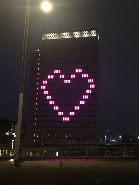 A Large Building With A Heart On Its Side In The Night Time Sky