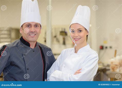 Male And Female Chef Posing In Restaurant Kitchen Stock Photo Image