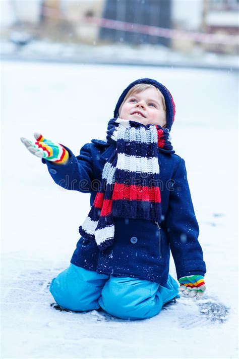 Cute Little Funny Boy In Colorful Winter Clothes Having Fun With Stock