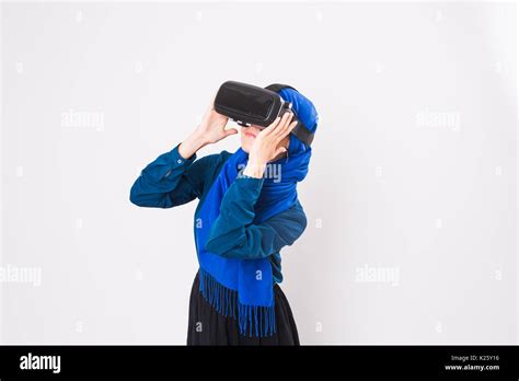 Asian Muslim Woman Wearing Hijab Using Vr Headset Glasses Of Virtual Reality On White Background