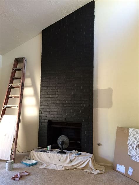 Satin Black Paint Enlivens This Brick Fireplace Black