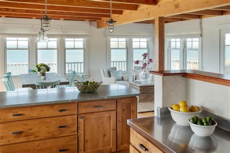 A Bowl Of Fruit Is Sitting On The Kitchen Counter Next To An Island In