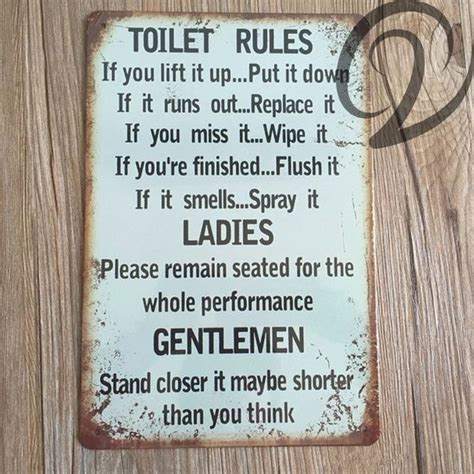 A Sign That Is On The Side Of A Wooden Wall Saying Toilet Rules If You Lift It Up Put It Down