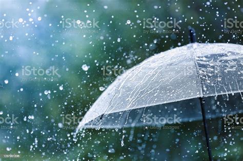 Transparent Umbrella Under Rain Against Water Drops Splash Background