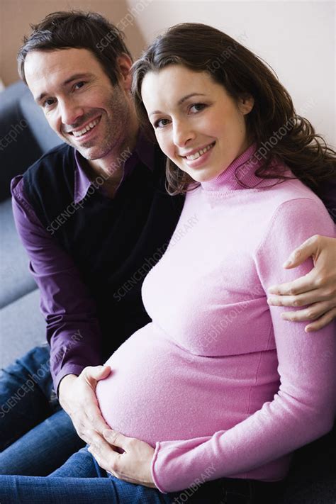 Pregnant Woman And Man Sitting On Couch Stock Image F003 2186 Science Photo Library