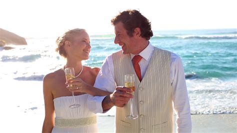 Newlyweds Drinking Champagne On The Beach Stock Footage Videohive