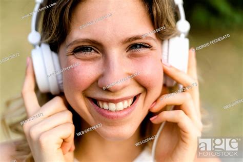 Portrait Of Happy Young Woman Listening Music With Headphones Stock