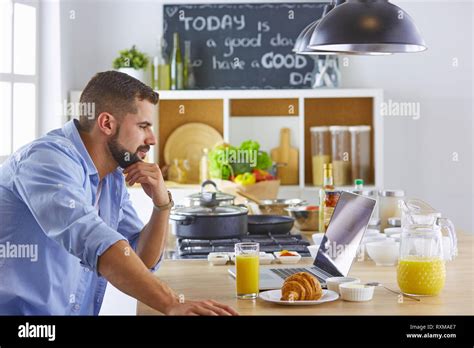 A Business Man Breakfasts With Notebook And Juice Stock Photo Alamy