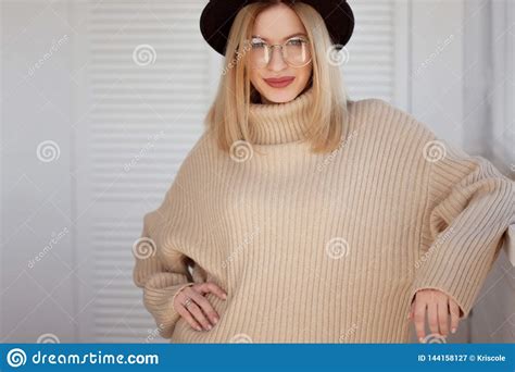 Stylish And Beautiful Young Blonde In Black Felt Hat And Beige Oversize Sweater Young Woman