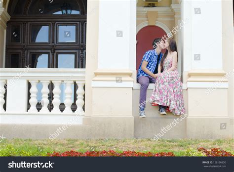 Young Happy Smiling Teen Couple Kissing On Old House