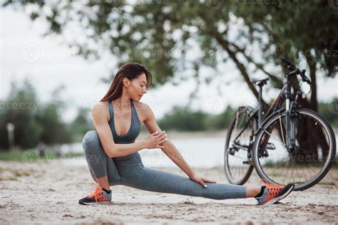 Concentrated Look Female Cyclist With Good Body Shape Doing Yoga