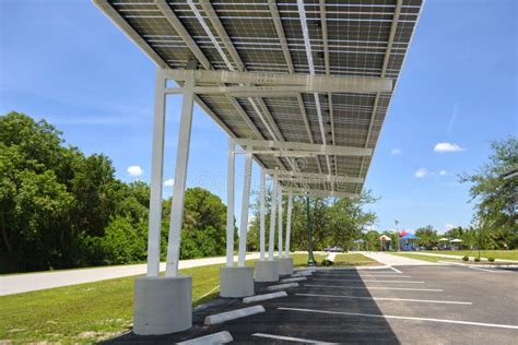 Solar Panels Installed As Shade Roof Over Parking Lot For Parked