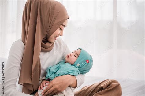Happy Muslim Mother Holding Adorable Little Baby Daughter Wearing Hijab