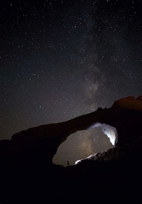 Silhouette Photo Person Stand Rocks Nighttime Cave Skyline Arch