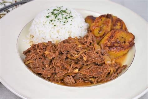 Ropa Vieja Served With White Rice And Fried Sweet Plantains Served On A