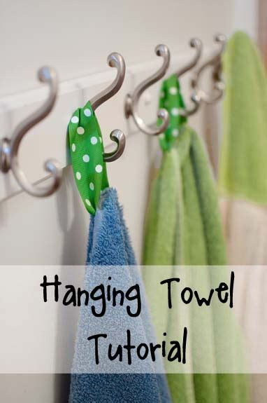 Large bath towels hang neatly on hooks designated with the initials of each user. Hanging Towel Tutorial