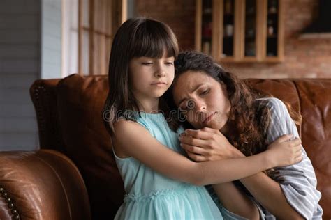 Close Up Caring Little Girl Comforting Hugging Depressed Mother Stock
