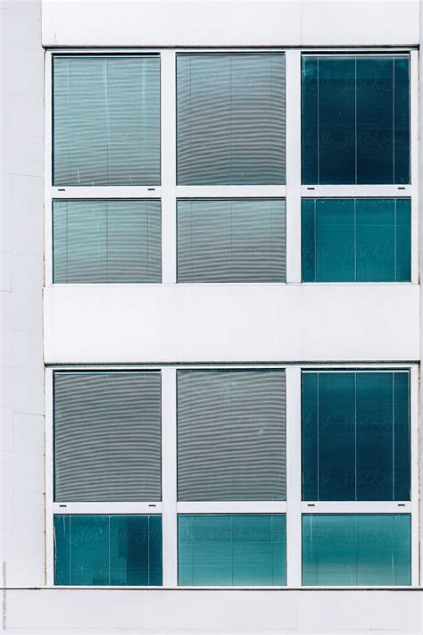 Abstract White Facade With Blue Windows By Stocksy Contributor