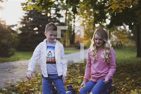 brother and sisters outdoors in fall — photo — lightstock
