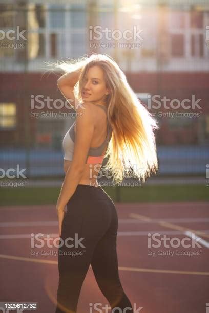 Attractive Fitness Model With Perfect Body And Long Lush Hair Posing On