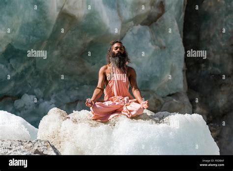 A Sadhu Holy Man Is Sitting And Meditating In Lotus Pose Padmasana