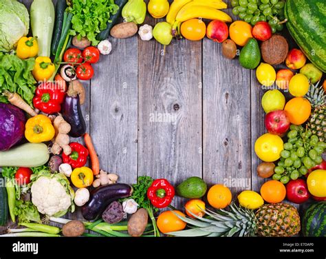 Collection Of Fresh Fruit And Vegetables On Wooden Table In Form Of