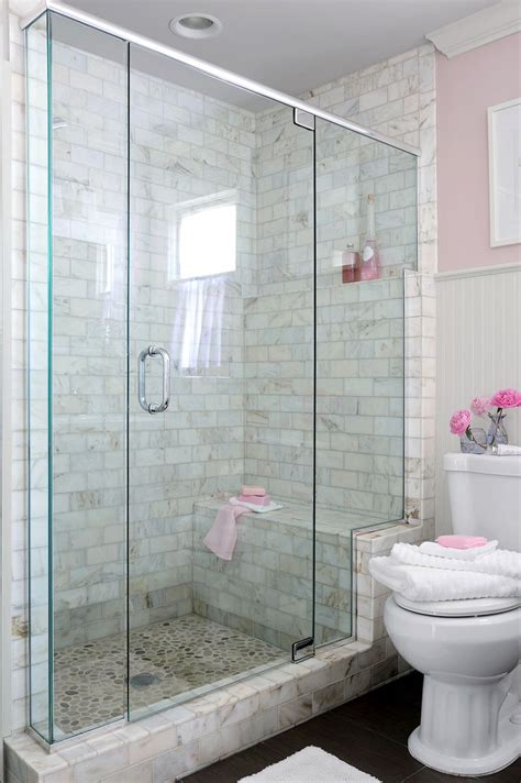 A White Toilet Sitting Next To A Walk In Shower Under A Bathroom Window