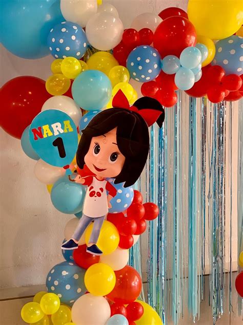 A Balloon Arch With Balloons Streamers And Decorations