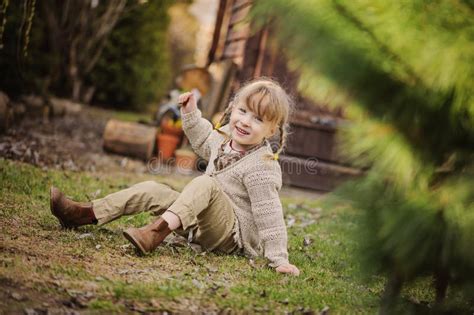 Cute Blonde Child Girl Having Fun In Early Spring Garden Stock Image